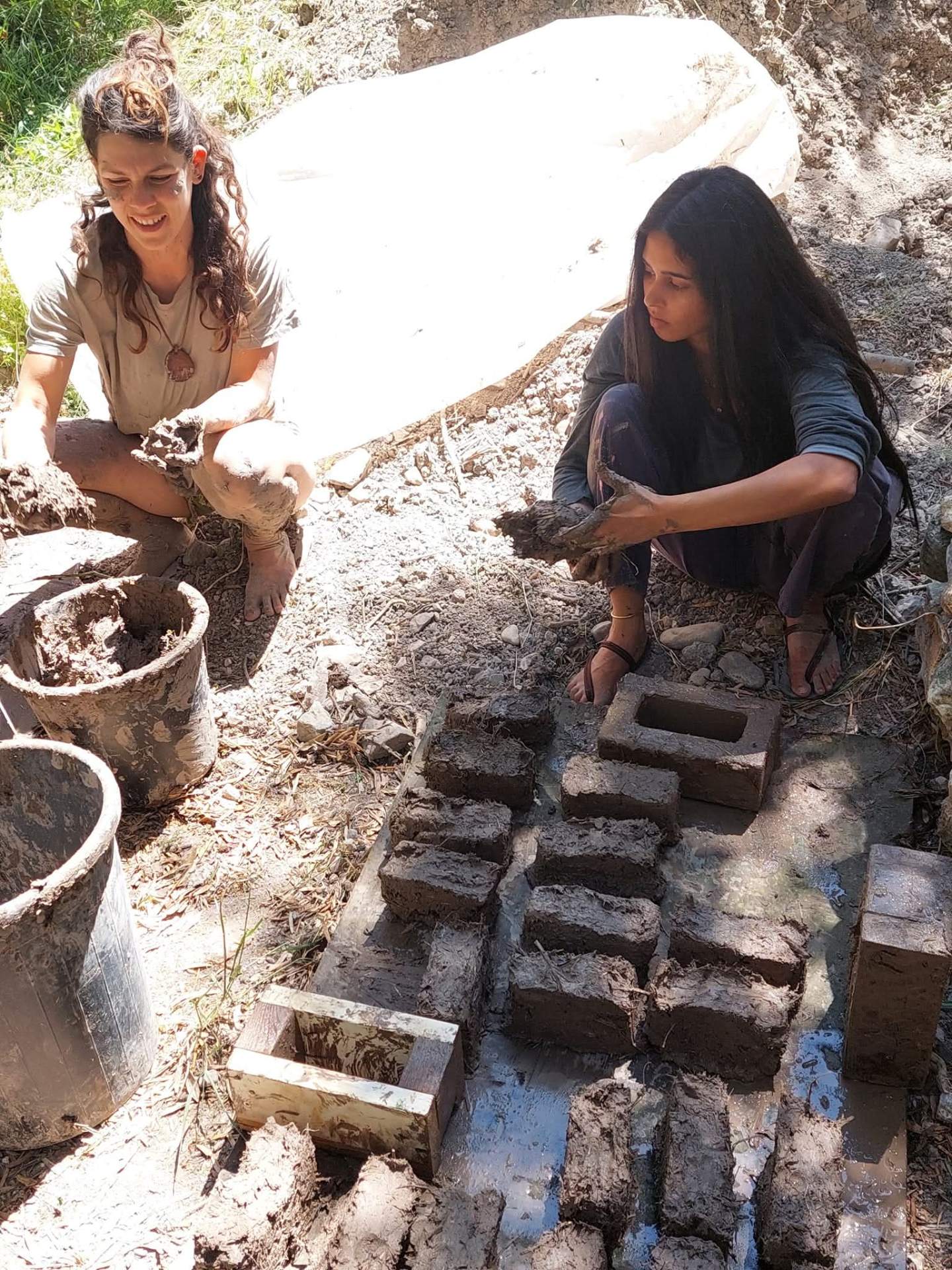 Hand-formed mud bricks drying in the sun